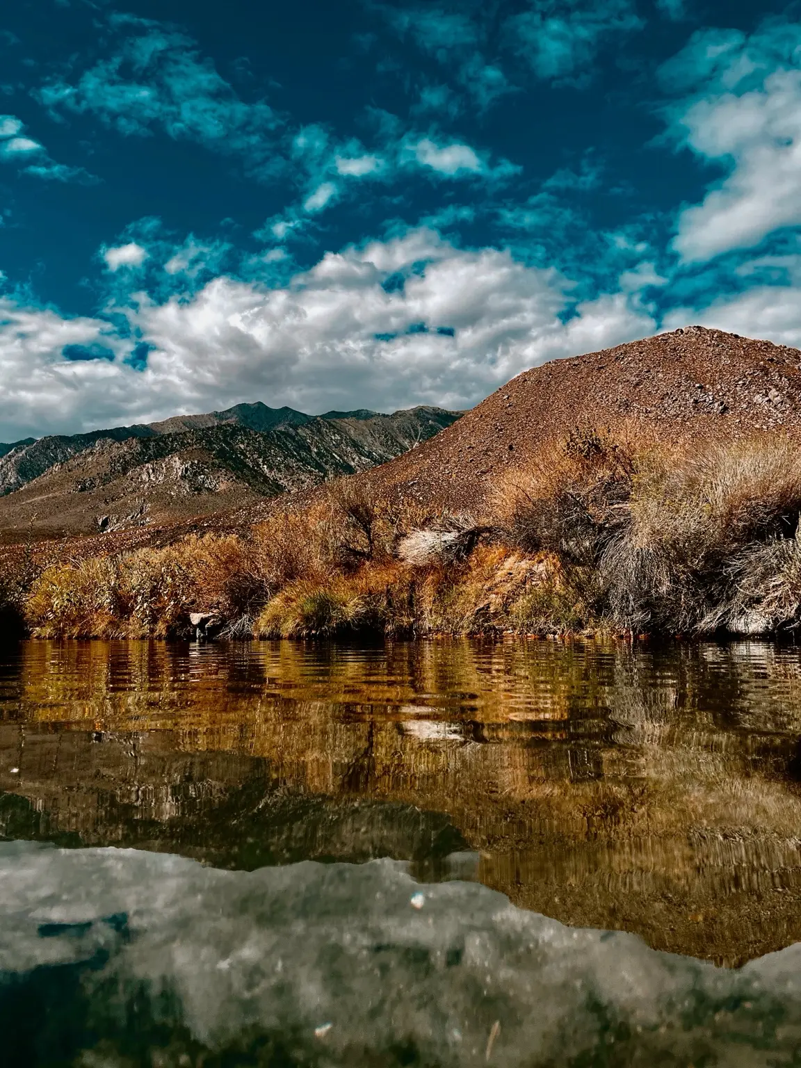 Autumn reflections beneath rugged hills