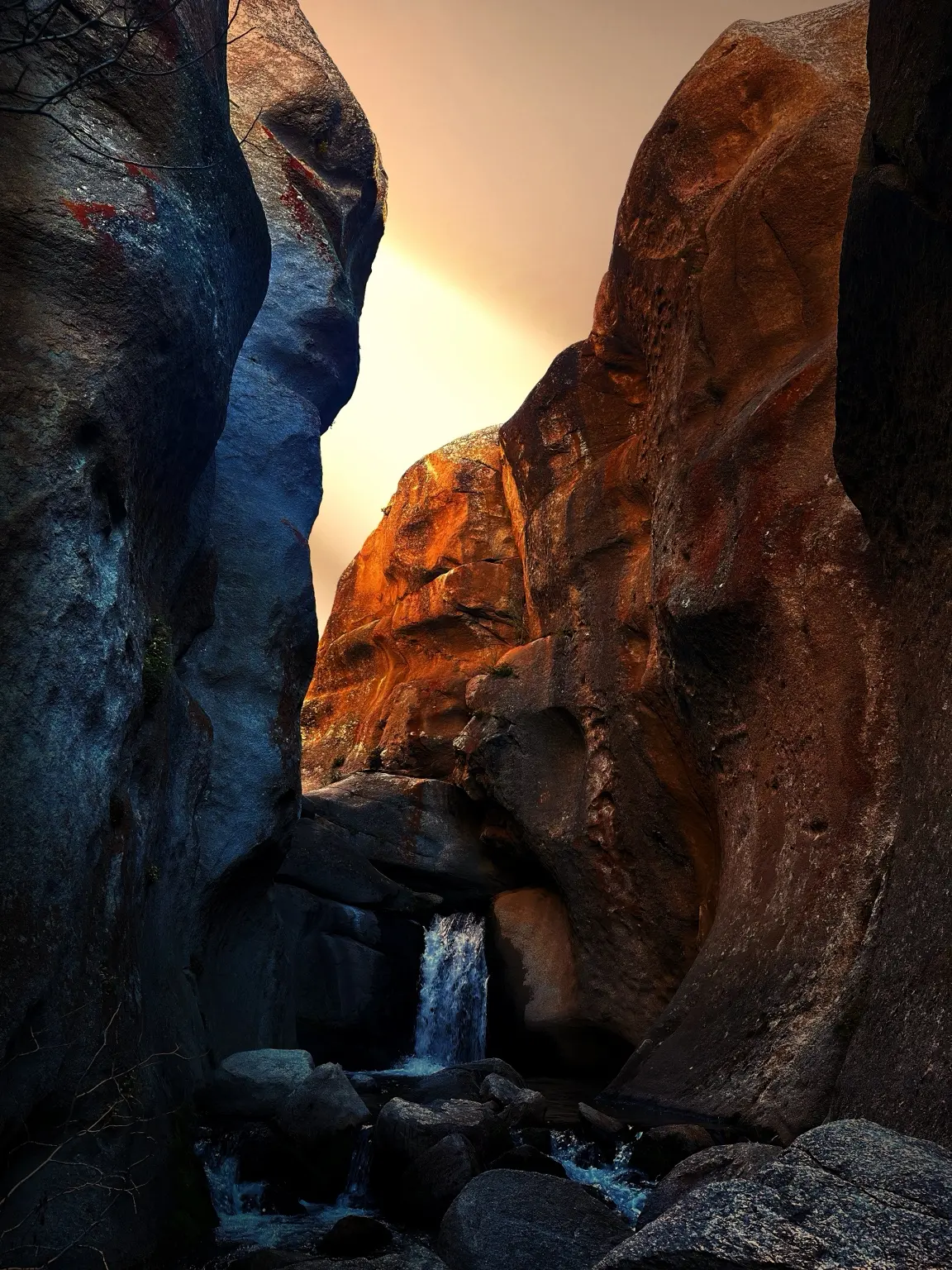 Hiker moving through a narrow red-rock passage