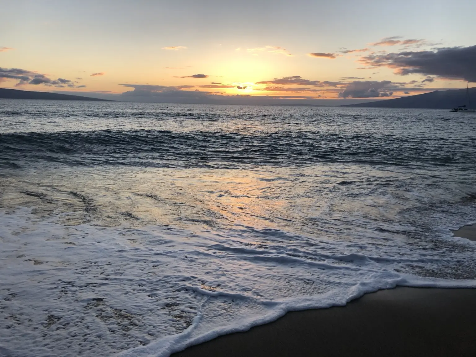 Sun setting over ocean waves