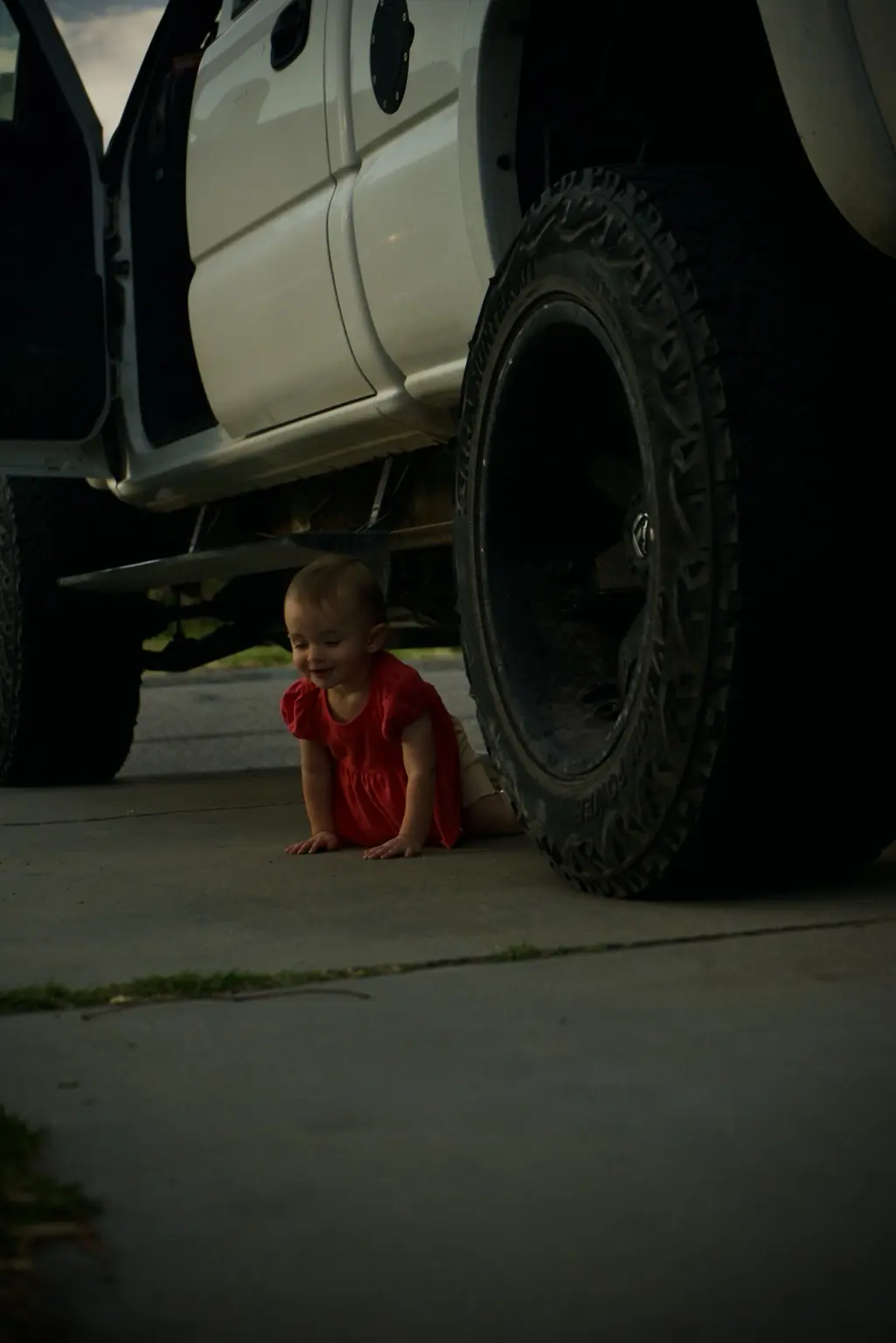 Child exploring beside an off-road vehicle
