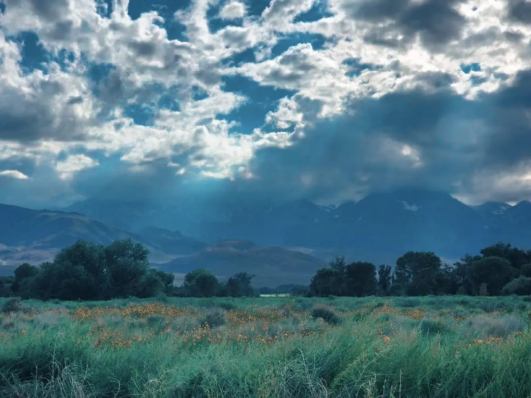 Sunbeams breaking through clouds over the valley
