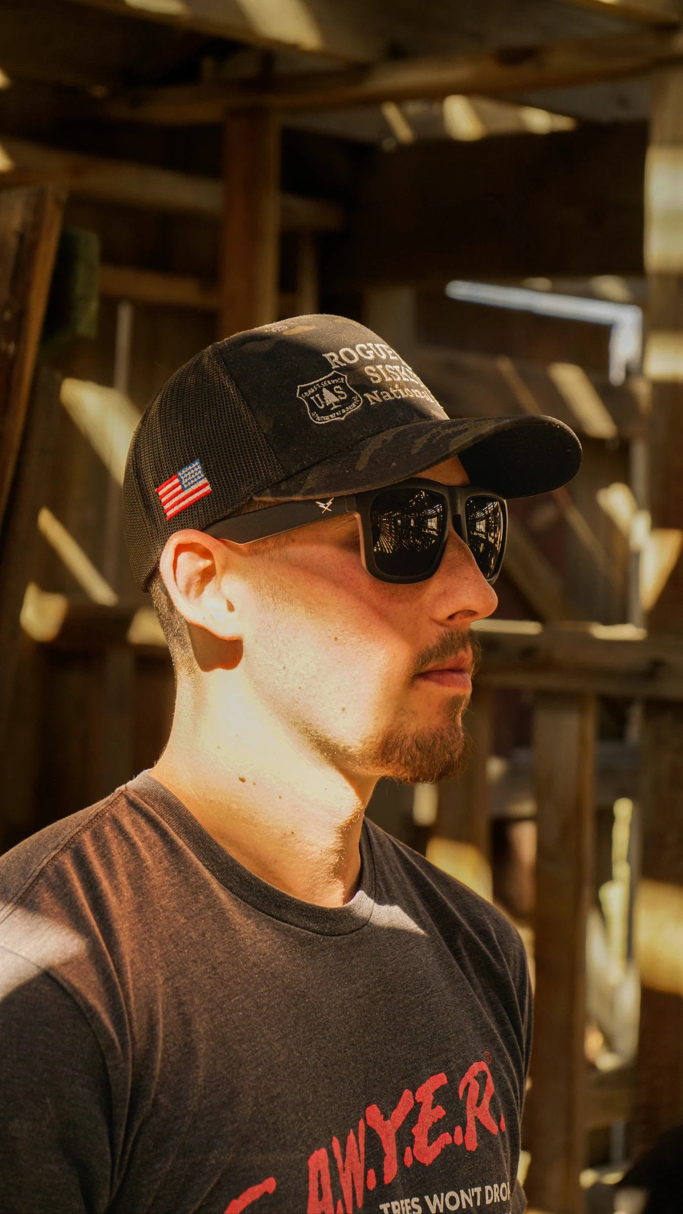 Portrait in warm light inside a wooden barn