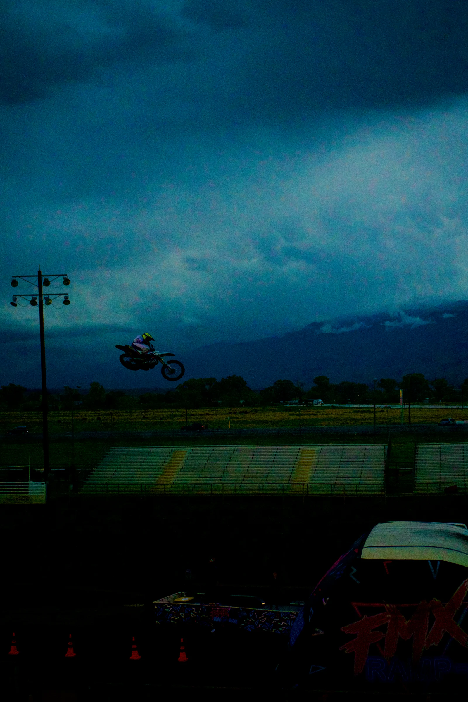 Airborne rider against a dramatic blue storm sky