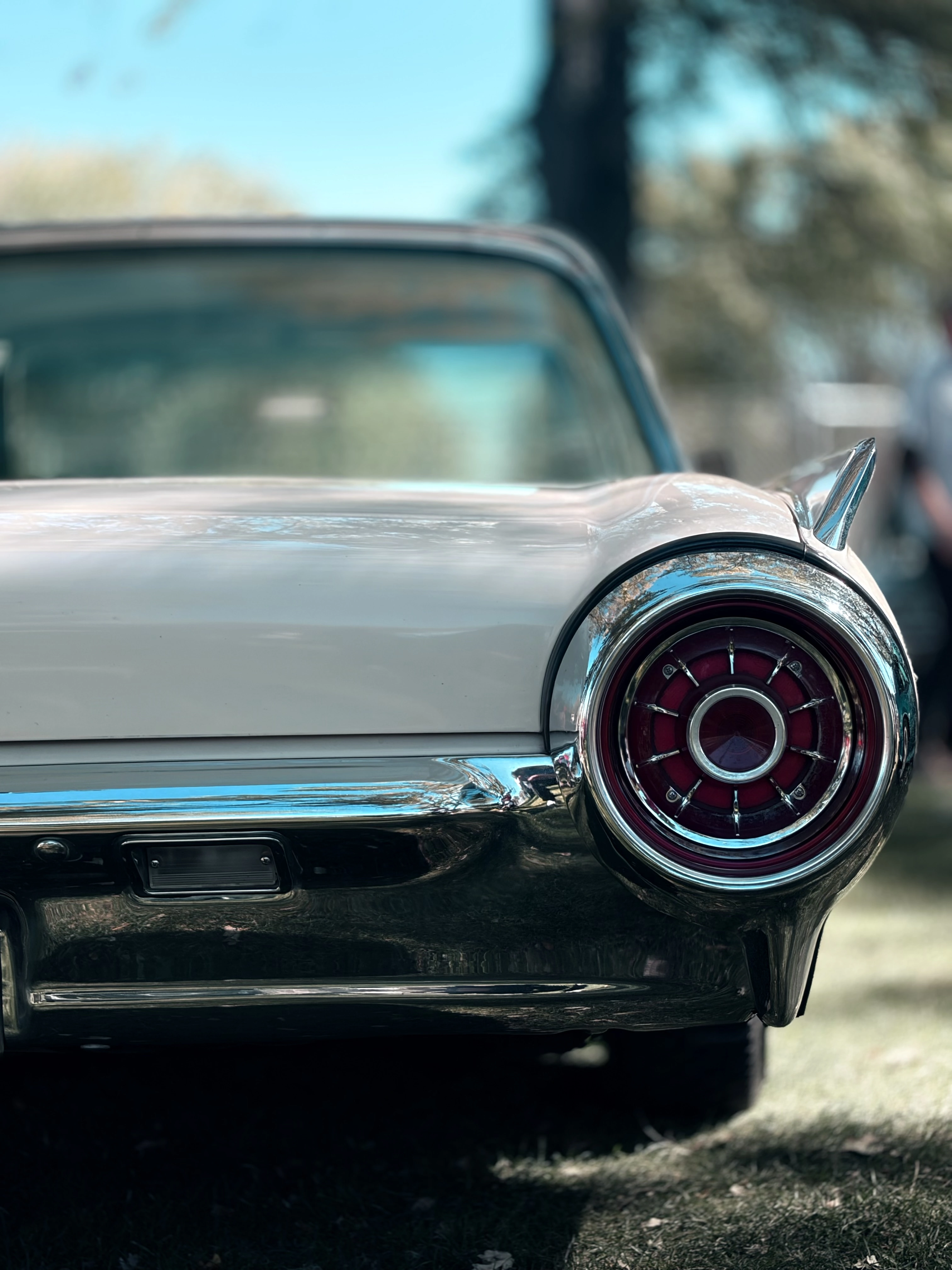Chrome tail fin and round red taillight on a classic car